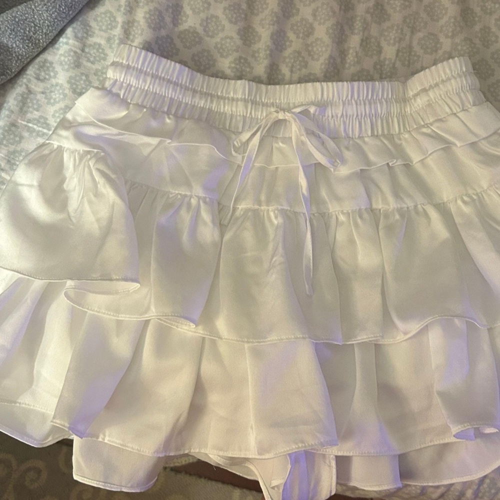 These three boutique white mini skort